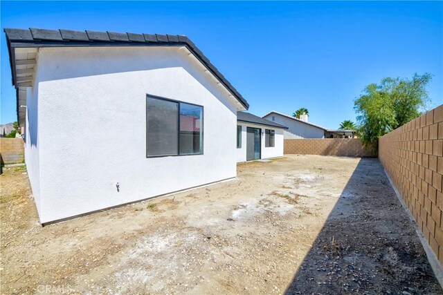 47432 Bahama Ct, Indio, CA 92201 - rear view of house with stucco siding and a fenced backyard