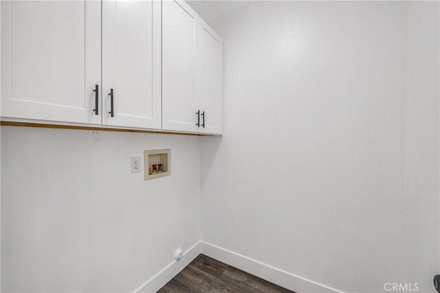 47432 Bahama Ct, Indio, CA 92201 - laundry room with cabinet space, baseboards, dark wood-type flooring, and washer hookup