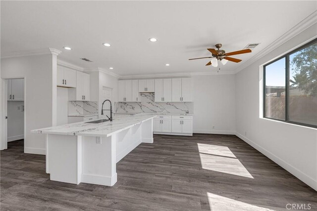47432 Bahama Ct, Indio, CA 92201 - kitchen with crown molding, a ceiling fan, white cabinets, recessed lighting, and decorative backsplash