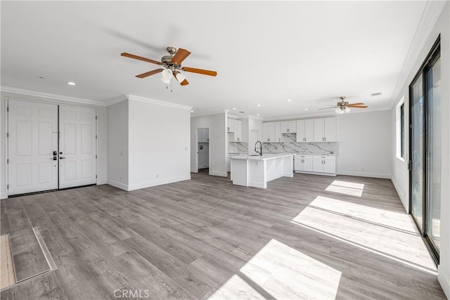 47432 Bahama Ct, Indio, CA 92201 - unfurnished living room with ceiling fan, ornamental molding, recessed lighting, a sink, and baseboards