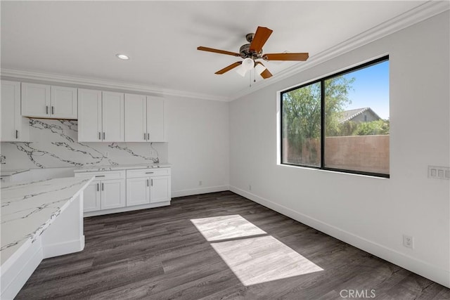 47432 Bahama Ct, Indio, CA 92201 - kitchen featuring ceiling fan, ornamental molding, white cabinets, dark wood finished floors, and decorative backsplash