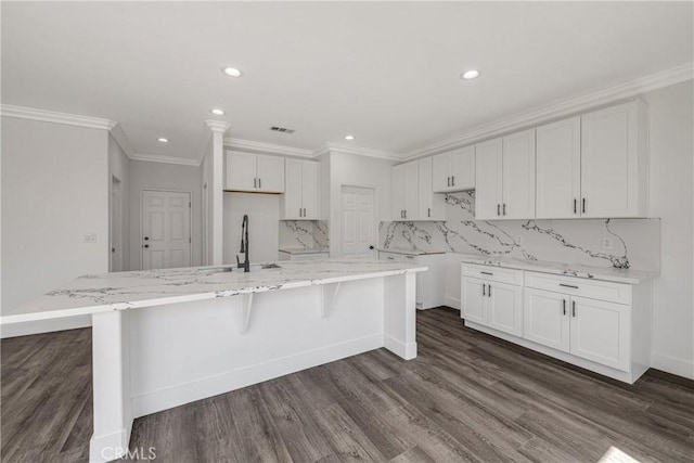 47432 Bahama Ct, Indio, CA 92201 - kitchen featuring a sink, light stone counters, recessed lighting, white cabinets, and ornamental molding
