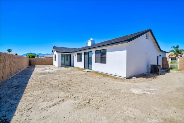 47432 Bahama Ct, Indio, CA 92201 - back of property with a fenced backyard, a chimney, and stucco siding