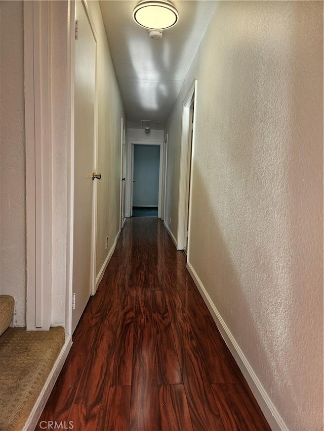 7019 Chimineas Ave, Reseda, CA 91335 - corridor with dark wood finished floors, baseboards, and a textured wall