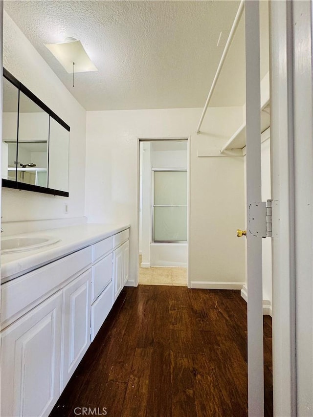 7019 Chimineas Ave, Reseda, CA 91335 - full bath featuring hardwood / wood-style flooring, vanity, a textured ceiling, a shower, and baseboards