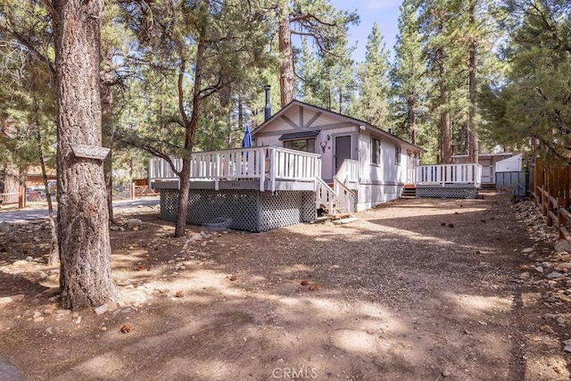 2032 Cedar Pine Ln, Big Bear City, CA 92314 - view of side of home featuring a deck, fence, and view of wooded area