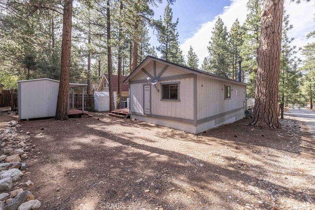 2032 Cedar Pine Ln, Big Bear City, CA 92314 - view of home's exterior with a storage unit and an outbuilding