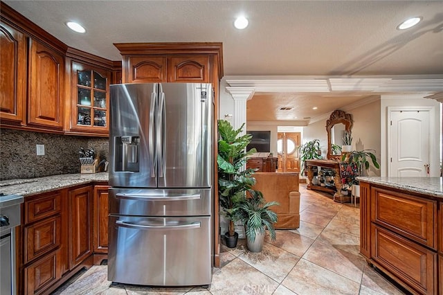 1704 Pass And Covina Rd, West Covina, CA 91792 - kitchen featuring stainless steel refrigerator with ice dispenser, crown molding, brown cabinetry, light stone countertops, and glass insert cabinets