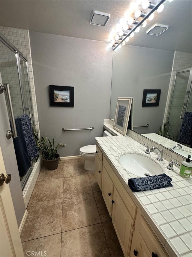 34300 Lantern Bay Dr Unit 41, Dana Point, CA 92629 - bathroom with a shower stall, vanity, toilet, and tile patterned floors