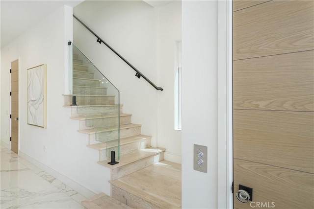 125 8th St, Huntington Beach, CA 92648 - staircase with marble look tile flooring and baseboards