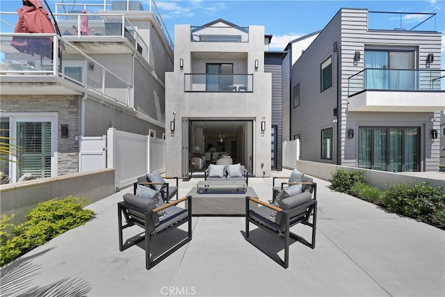 125 8th St, Huntington Beach, CA 92648 - back of property featuring outdoor lounge area, a balcony, fence, a patio, and stucco siding