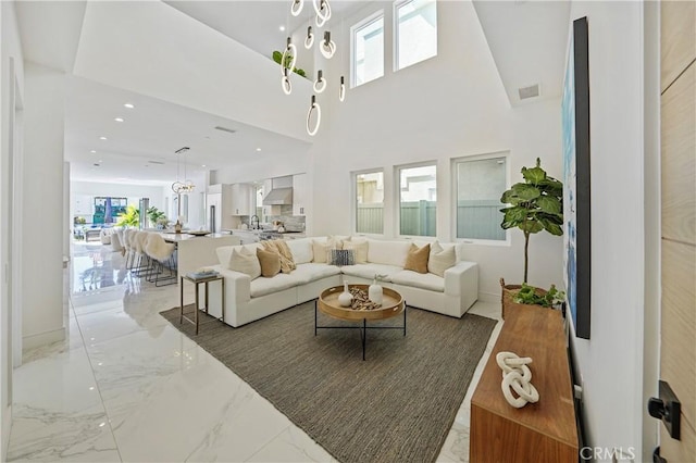 125 8th St, Huntington Beach, CA 92648 - living area featuring light marble finish flooring and healthy amount of natural light