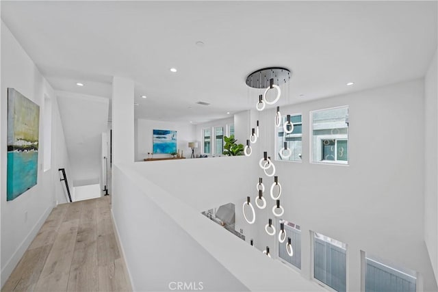 125 8th St, Huntington Beach, CA 92648 - hallway with wood finished floors, recessed lighting, baseboards, and an upstairs landing
