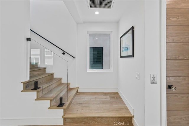 125 8th St, Huntington Beach, CA 92648 - stairway featuring wood finished floors, baseboards, and recessed lighting