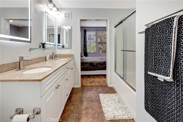 2230 Watermarke Pl, Irvine, CA 92612 - ensuite bathroom featuring double vanity, tile patterned flooring, and combined bath / shower with glass door