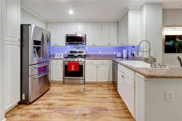 2230 Watermarke Pl, Irvine, CA 92612 - kitchen featuring stainless steel appliances, a sink, white cabinetry, and recessed lighting