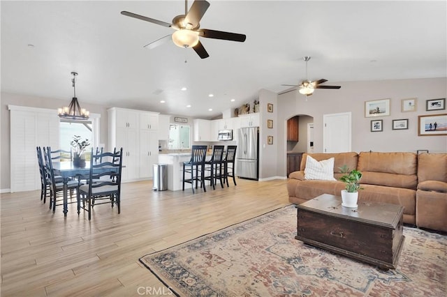 5824 White Fox Trl, Phelan, CA 92371 - living area with ceiling fan, vaulted ceiling, arched walkways, light wood finished floors, and recessed lighting
