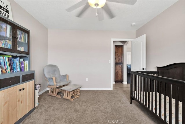 5824 White Fox Trl, Phelan, CA 92371 - carpeted bedroom featuring a crib, baseboards, and ceiling fan