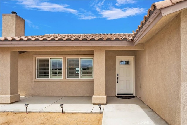 5824 White Fox Trl, Phelan, CA 92371 - view of exterior entry featuring a patio area and stucco siding