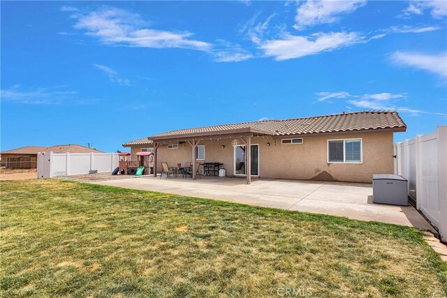 5824 White Fox Trl, Phelan, CA 92371 - back of property featuring stucco siding, a tile roof, a patio, and a playground
