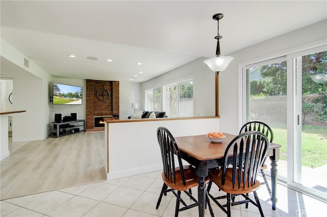 22492 Eloise Dr, Lake Forest, CA 92630 - dining space featuring a brick fireplace, recessed lighting, baseboards, and light tile patterned floors
