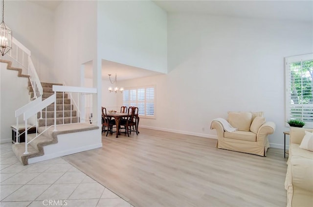 22492 Eloise Dr, Lake Forest, CA 92630 - living room with a chandelier, a high ceiling, stairway, wood finished floors, and healthy amount of natural light