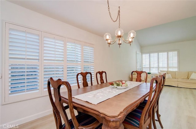 22492 Eloise Dr, Lake Forest, CA 92630 - dining room featuring light wood-style flooring, a chandelier, baseboards, and lofted ceiling