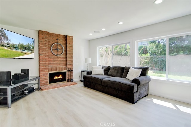22492 Eloise Dr, Lake Forest, CA 92630 - living room featuring wood finished floors, recessed lighting, plenty of natural light, a brick fireplace, and baseboards