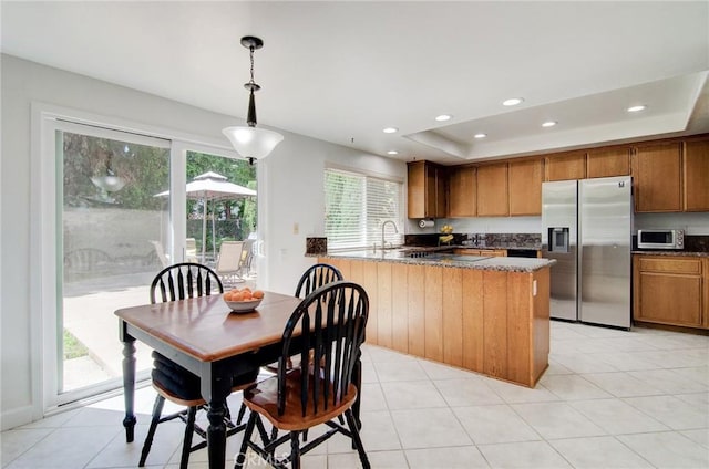 22492 Eloise Dr, Lake Forest, CA 92630 - kitchen featuring stainless steel appliances, brown cabinets, a peninsula, pendant lighting, and recessed lighting