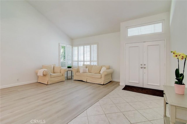 22492 Eloise Dr, Lake Forest, CA 92630 - entryway featuring high vaulted ceiling, baseboards, and light wood finished floors