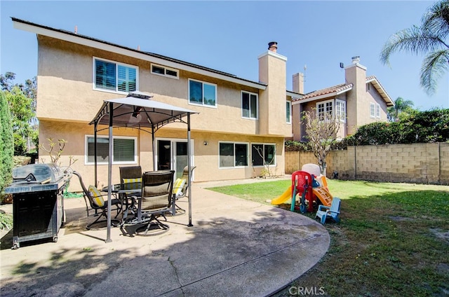 22492 Eloise Dr, Lake Forest, CA 92630 - rear view of property featuring stucco siding, a patio, and a chimney