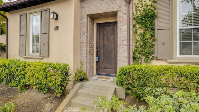 86 Canyoncrest, Irvine, CA 92603 - doorway to property featuring stucco siding
