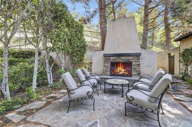 86 Canyoncrest, Irvine, CA 92603 - view of patio / terrace with an outdoor stone fireplace and fence