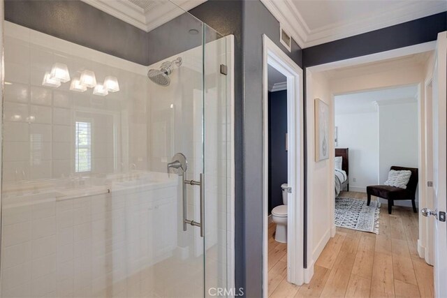 86 Canyoncrest, Irvine, CA 92603 - full bathroom featuring hardwood / wood-style flooring, a stall shower, toilet, ornamental molding, and ensuite bath