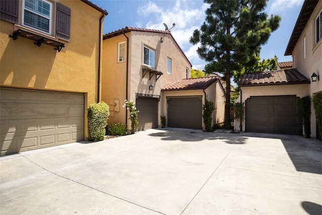 86 Canyoncrest, Irvine, CA 92603 - mediterranean / spanish-style house featuring stucco siding, a tile roof, and a garage