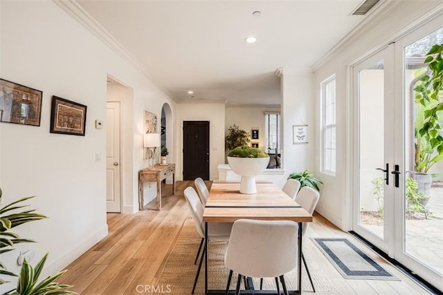 86 Canyoncrest, Irvine, CA 92603 - dining area featuring french doors, arched walkways, light wood finished floors, baseboards, and ornamental molding