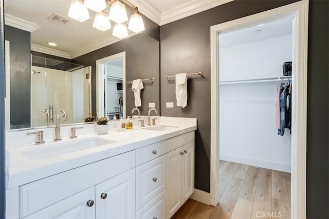 86 Canyoncrest, Irvine, CA 92603 - bathroom with ornamental molding, a shower stall, wood finished floors, a spacious closet, and double vanity