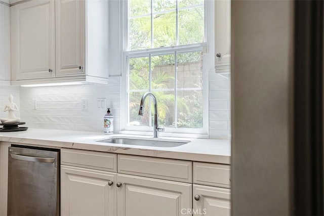 86 Canyoncrest, Irvine, CA 92603 - kitchen featuring a sink, stainless steel dishwasher, tasteful backsplash, white cabinetry, and light countertops
