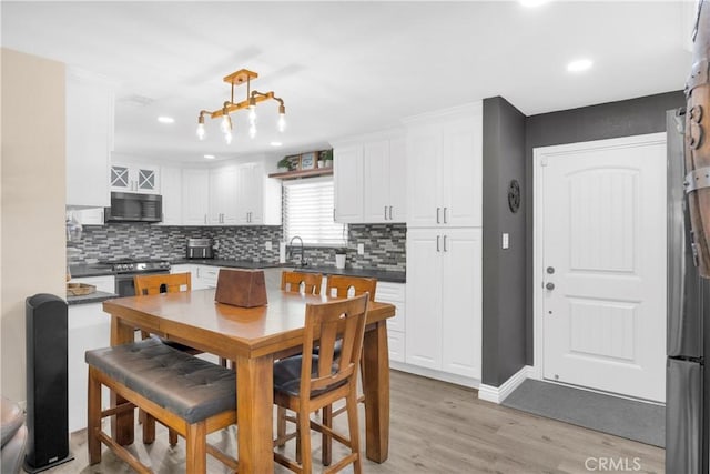 5182 Olga Ave, Cypress, CA 90630 - kitchen featuring appliances with stainless steel finishes, white cabinets, decorative backsplash, and recessed lighting
