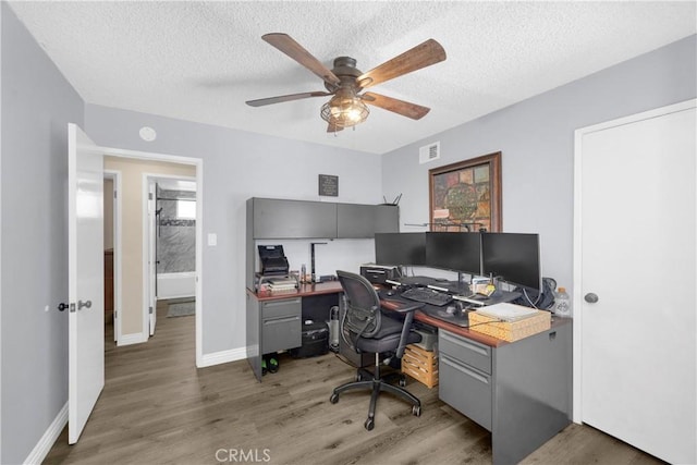 5182 Olga Ave, Cypress, CA 90630 - office area featuring wood finished floors, ceiling fan, a textured ceiling, and baseboards