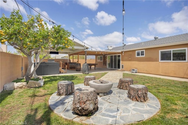 5182 Olga Ave, Cypress, CA 90630 - rear view of property featuring a hot tub, stucco siding, an outdoor fire pit, and a patio area