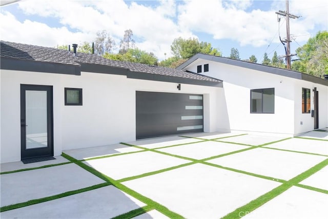 539 Avon Ave, Pasadena, CA 91105 - back of house with stucco siding, an attached garage, driveway, and a shingled roof