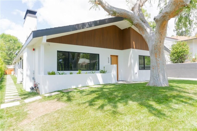539 Avon Ave, Pasadena, CA 91105 - back of house with a yard, a chimney, and stucco siding