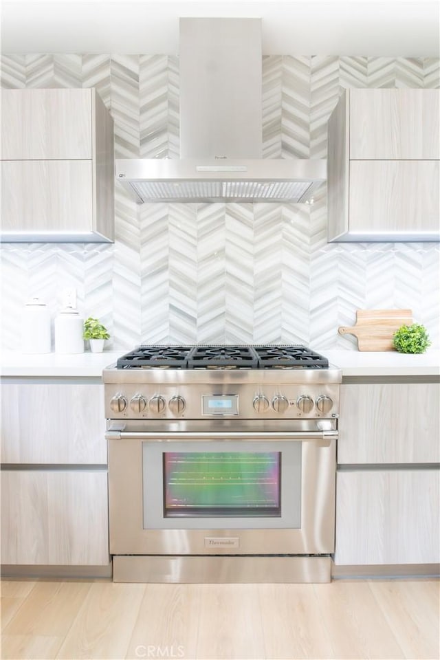 539 Avon Ave, Pasadena, CA 91105 - kitchen with high end stainless steel range, wall chimney range hood, light countertops, and light brown cabinetry