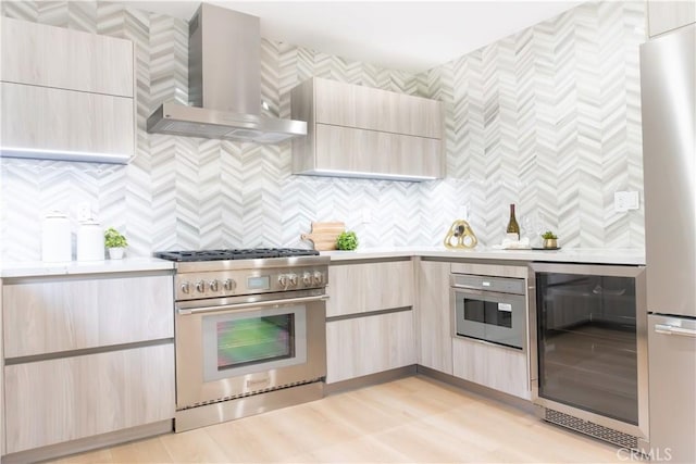 539 Avon Ave, Pasadena, CA 91105 - kitchen with stainless steel appliances, wall chimney exhaust hood, beverage cooler, light countertops, and light brown cabinetry