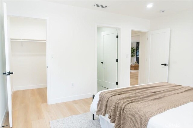 539 Avon Ave, Pasadena, CA 91105 - bedroom with a walk in closet, light wood-type flooring, baseboards, a closet, and recessed lighting