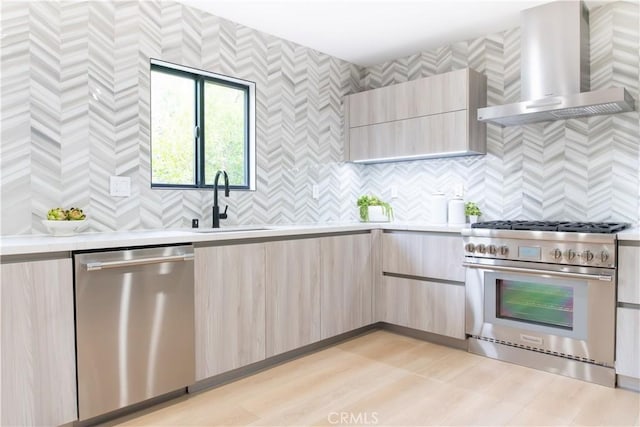 539 Avon Ave, Pasadena, CA 91105 - kitchen with appliances with stainless steel finishes, wall chimney exhaust hood, modern cabinets, light countertops, and a sink