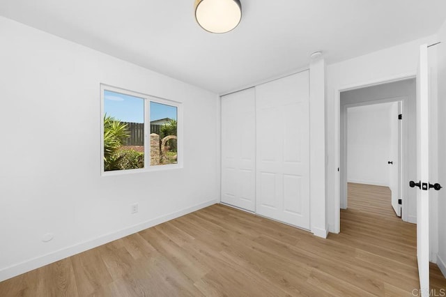 8184 Flanders Dr, San Diego, CA 92126 - unfurnished bedroom featuring light wood-style flooring, baseboards, and a closet