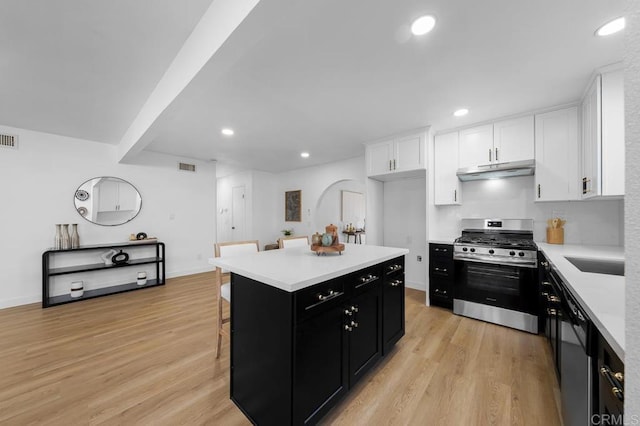 8184 Flanders Dr, San Diego, CA 92126 - kitchen with appliances with stainless steel finishes, dark cabinetry, under cabinet range hood, white cabinets, and light countertops