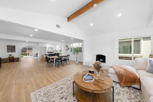 8184 Flanders Dr, San Diego, CA 92126 - living room with beam ceiling, recessed lighting, a fireplace with raised hearth, light wood finished floors, and high vaulted ceiling